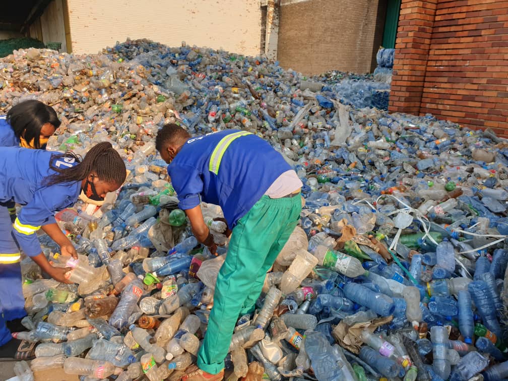 Alpha Polyplast workers sorting bottles